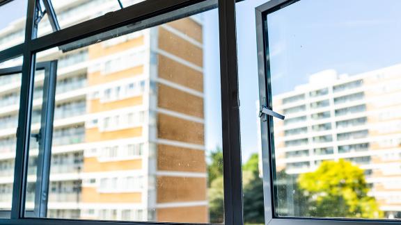 Blocks of flats viewed through a half-open window.