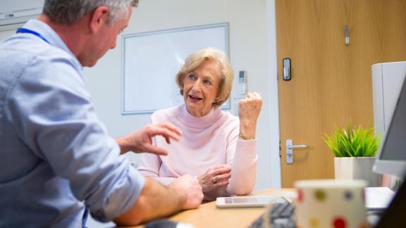 A GP consulting a female patient.