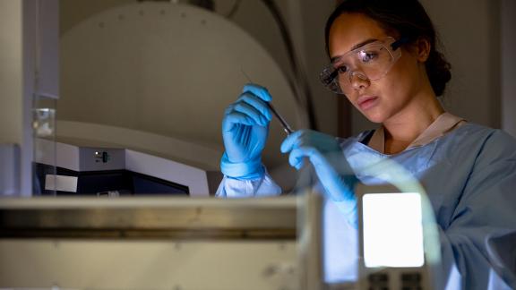 A healthcare scientist checking equipment.