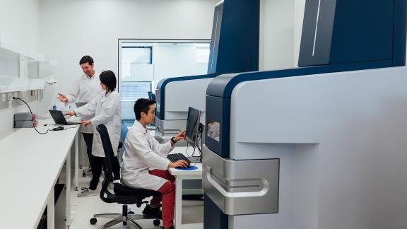 Healthcare scientists at a machine.