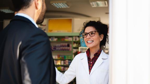 A pharmacist with customer.