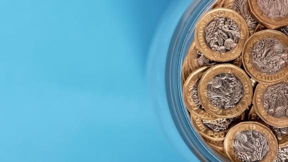 Pound coins in a glass.