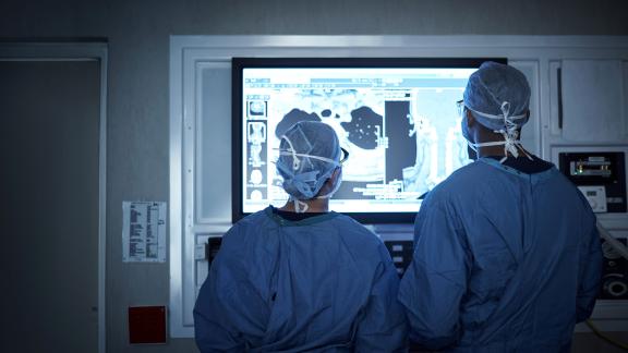 Two surgeons assessing a scan.
