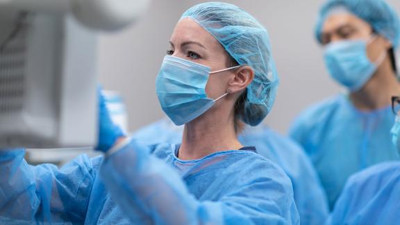 Two surgeons checking a monitor.