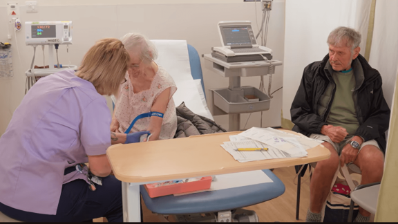 Older female patient being treated by a clinican