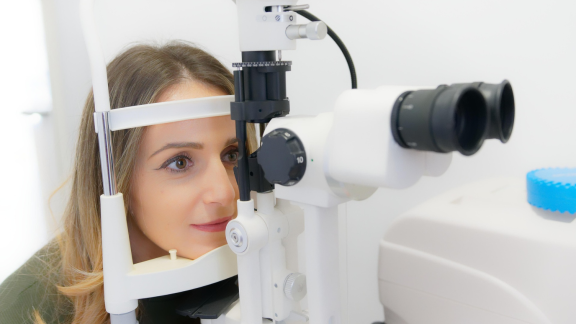 A woman receiving an eye scan