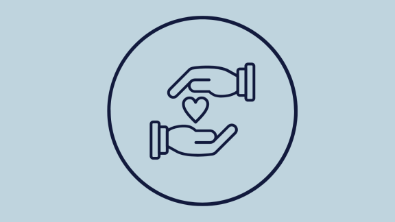 Two hands holding a heart to depict charity
