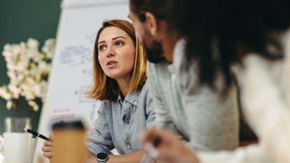 Woman looking concerned, talking in a meeting