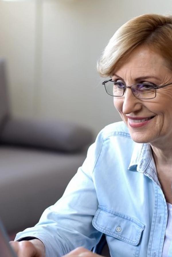 Image of lady looking at her laptop