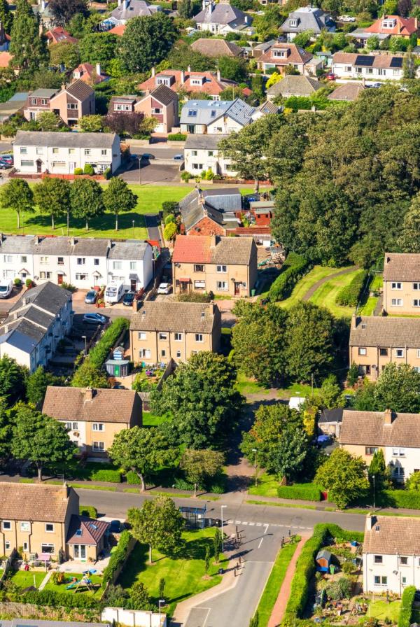 Aerial view of residential area with houses and cars