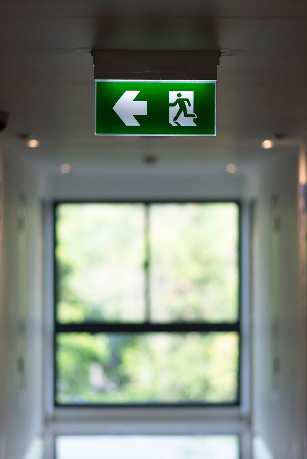 An exit sign in a hospital corridor.
