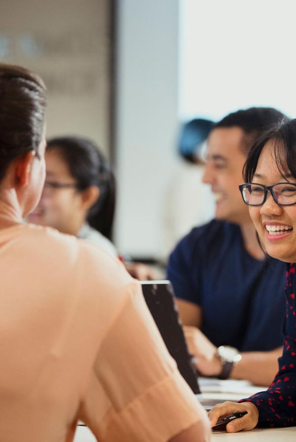 An office worker laughing.