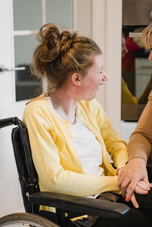 A patient and their carer, laughing.