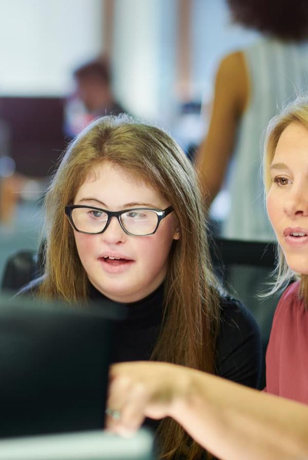 Image of two ladies looking at a computer