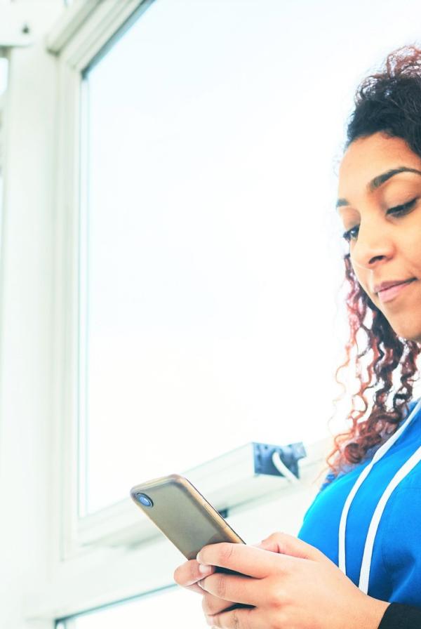 Health care worker reading on a phone