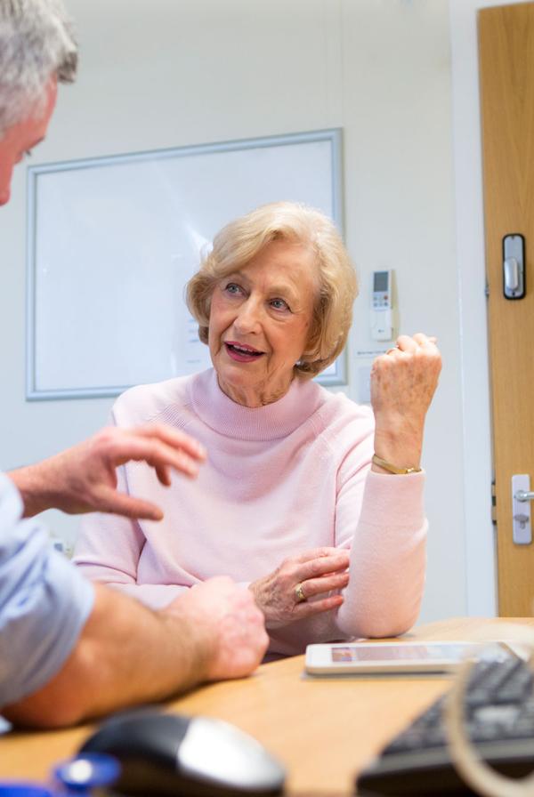 A GP consulting a female patient.