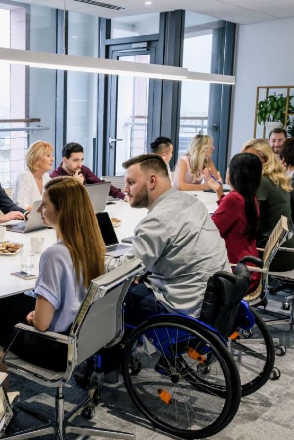 Diverse group sat around a boardroom table