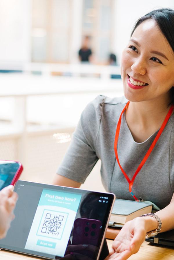 A delegate using a QR code to sign into an event.