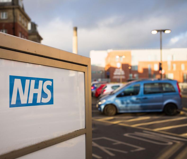 An NHS sign in a car park.