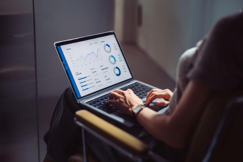 Woman looking at data dashboard on laptop