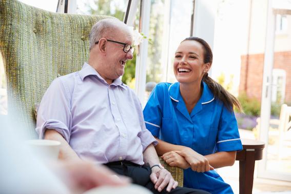A patient and community nurse laughing.