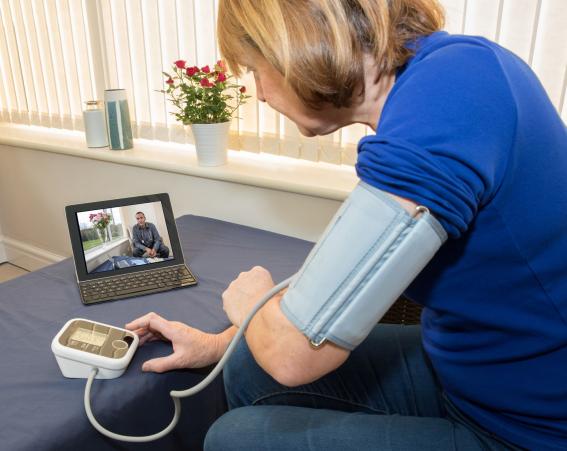 Video consultation as patient takes blood pressure